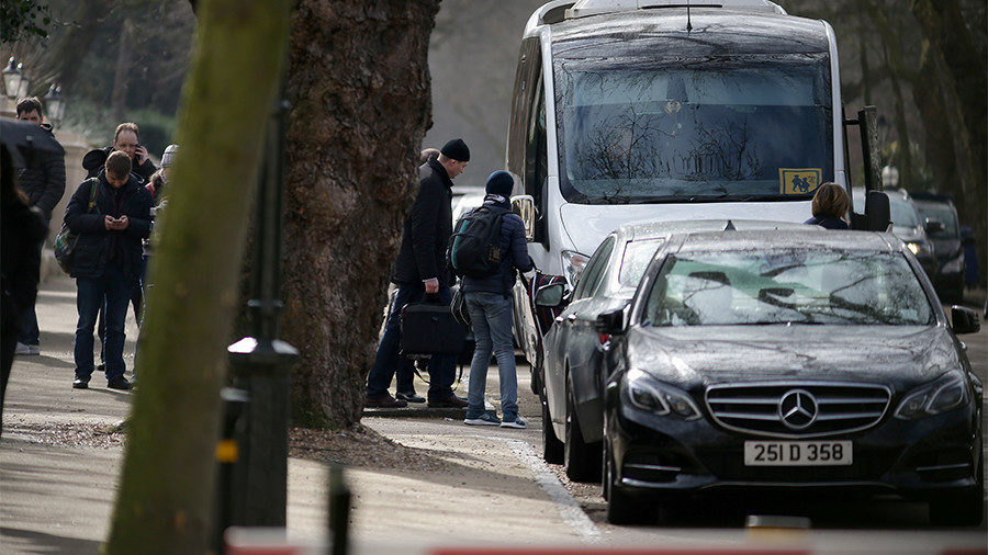 People carrying luggage leave the Russian Embassy in London on March 20, 2018