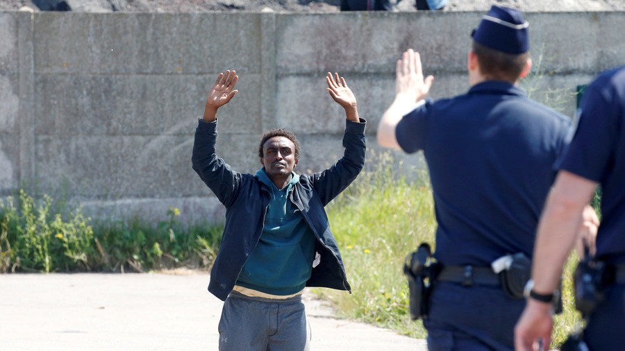 French police signal to a migrant, June 1, 2017