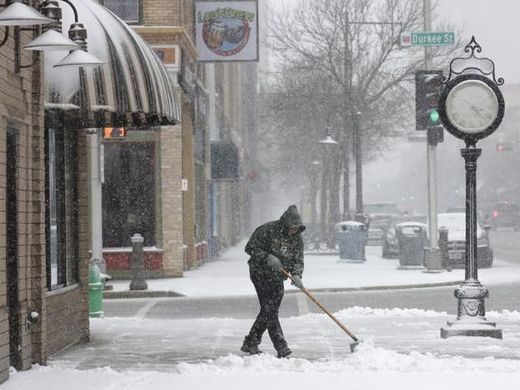 Ken Fritsch showels heavy snow in front of Avenue Jewelers along College Avenue Tuesday, April 3, 2018, in Appleton, Wis.