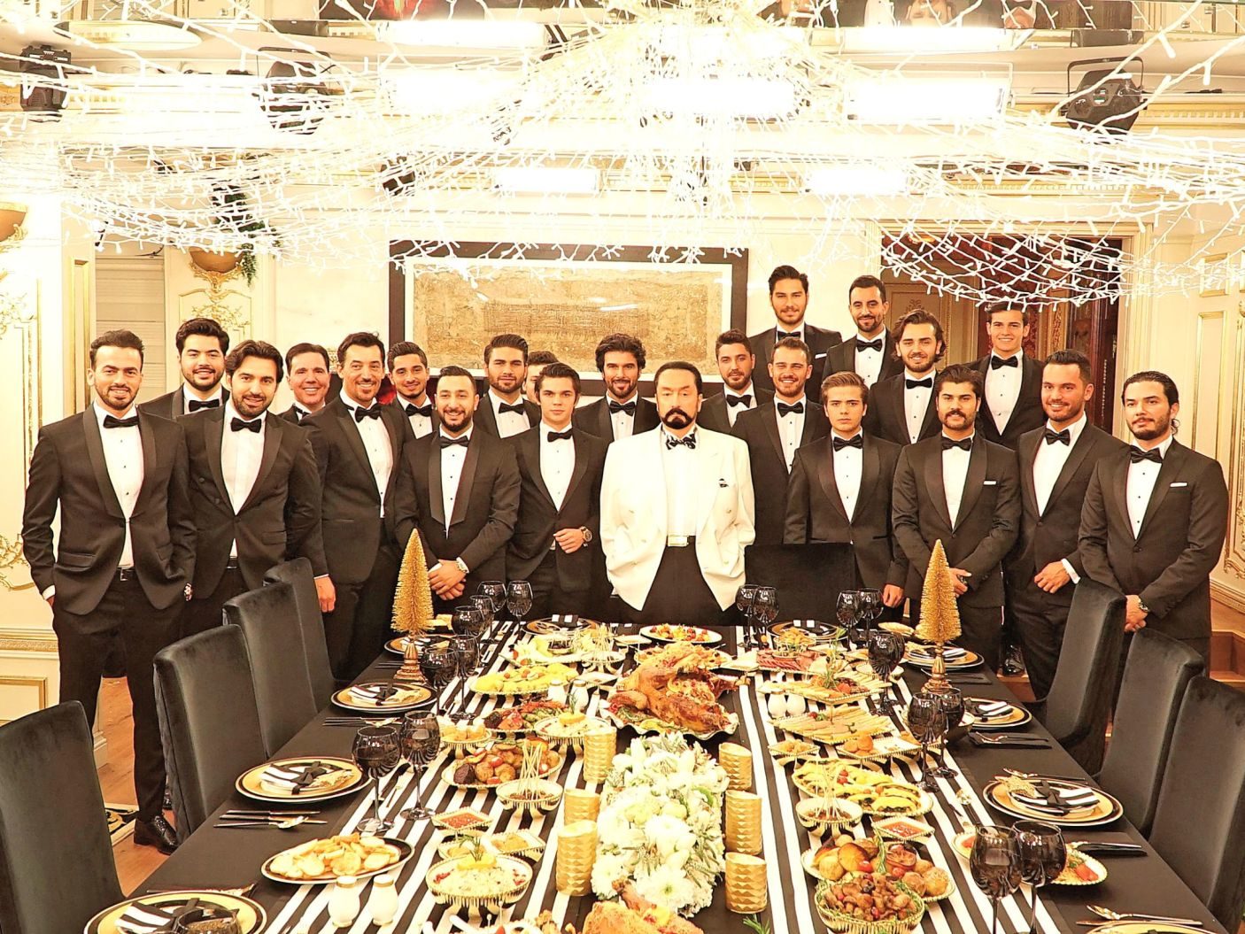 Click to enlarge Adnan Oktar with members of his cult.