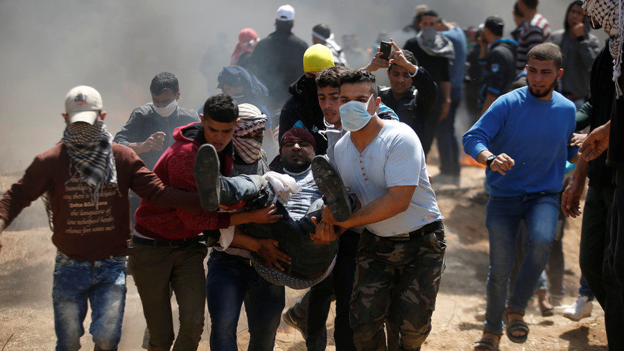 wounded Palestinian is evacuated during clashes with Israeli troops at the Israel-Gaza border, April 6, 2018