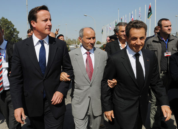 Photo: Prime Minister David Cameron (L) and French President Nicolas Sarkozy (R) with National Transitional Council (NTC) chairman Mustafa Abdul Jalil in Tripoli in September 2011