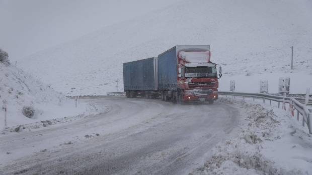Click to enlarge A truck drives through heavy snow at the top of Porters Pass, in the Canterbury region.