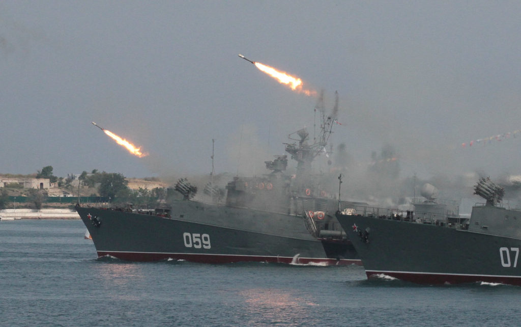 Click to enlarge Russian navy ships fire off missiles at a parade