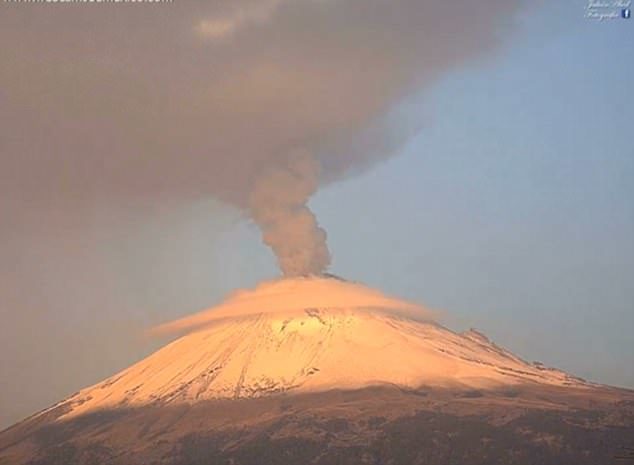 The smoke begins to turn a dark red colour as it continues spewing out of the volcano