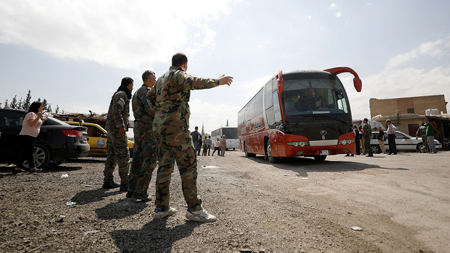 Click to enlarge Buses carry rebels and their families who left Douma
