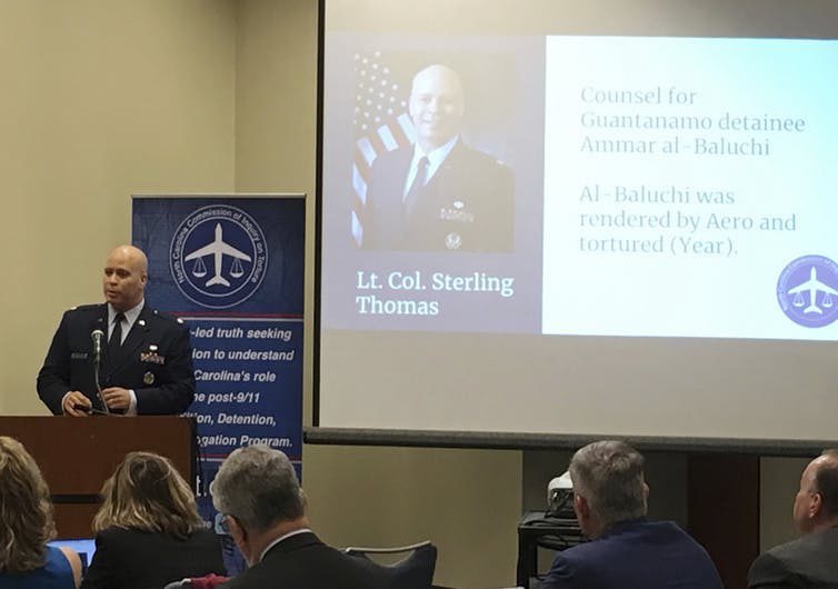 Click to enlarge Man speaks to the North Carolina Commission of Inquiry on Torture.
