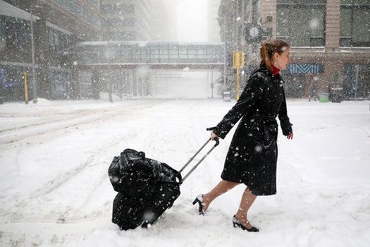 Click to enlarge Delta Airlines flight attendant Victoria Flees trudged through the snow with her bags in downtown Minneapolis