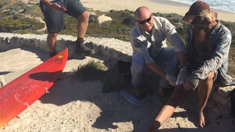 Jason Longgrass, 41, is treated by paramedics after he was bitten on his right leg at Lefties, the second shark attack in Gracetown today.