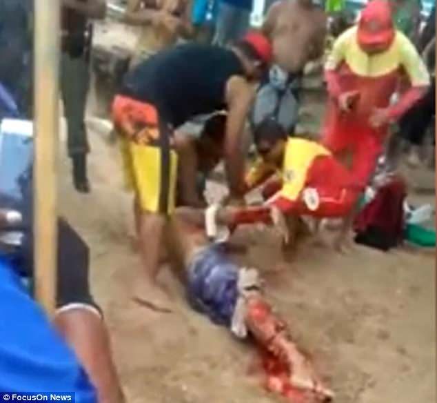 Dramatic footage shows paramedics battling to help the man while he lies on the beach covered in blood