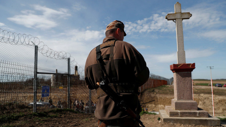 Click to enlarge A Hungarian soldier stands at the Hungarian-Serbian border on April 3, 2018.