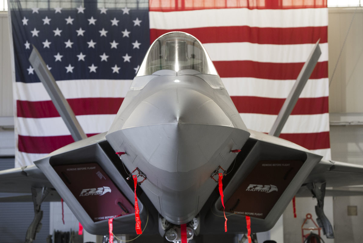 Click to enlarge US Air Force Lockheed Martin F-22 Raptor stealth fighter aircraft is parked inside a hangar