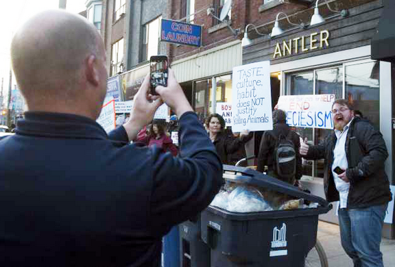 Click to enlarge The protest outside Antler Kitchen and Bar on Dundas Street West in Toronto on April 12.