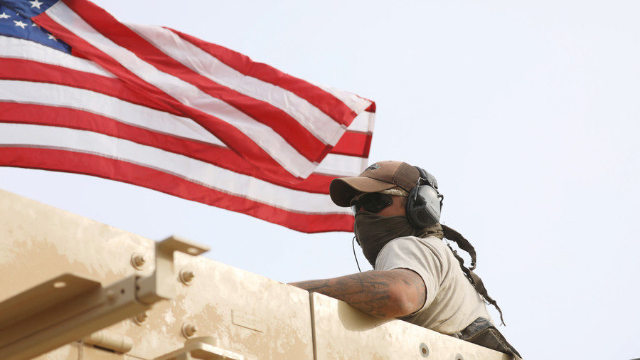 Click to enlarge A US soldier rides a military vehicle