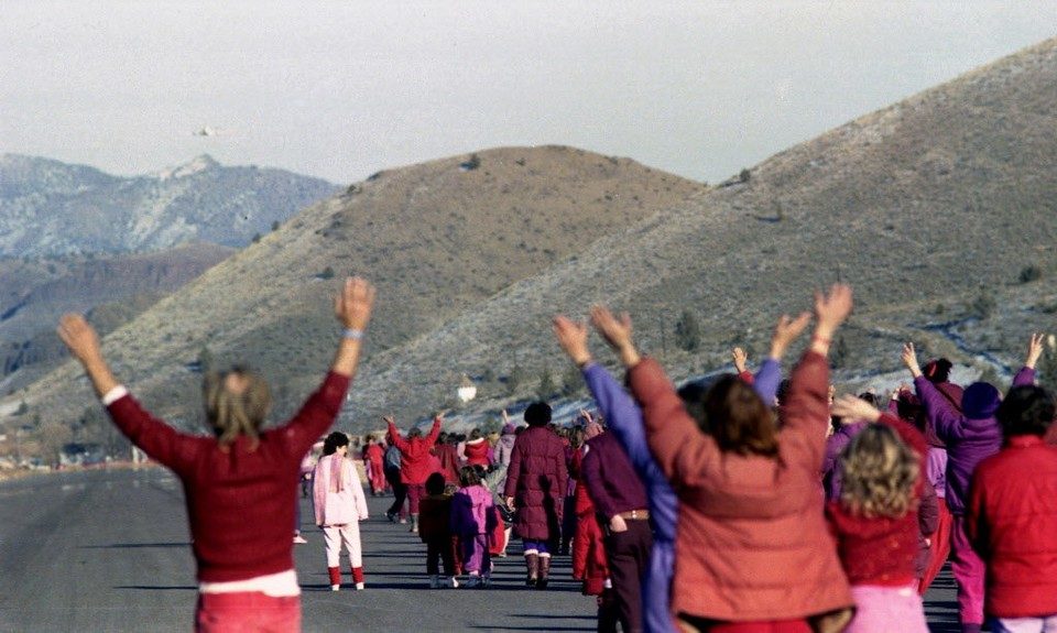 Click to enlarge cult members flag down plane