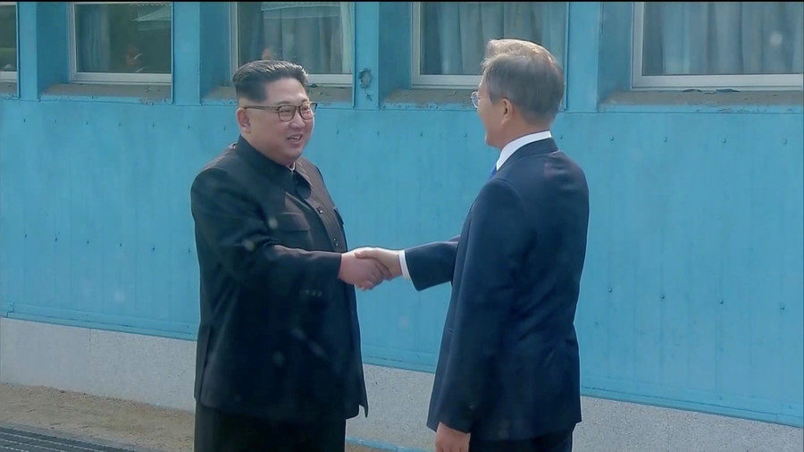Click to enlarge North Korean leader Kim Jong-un shakes hands with South Korean President Moon Jae-in