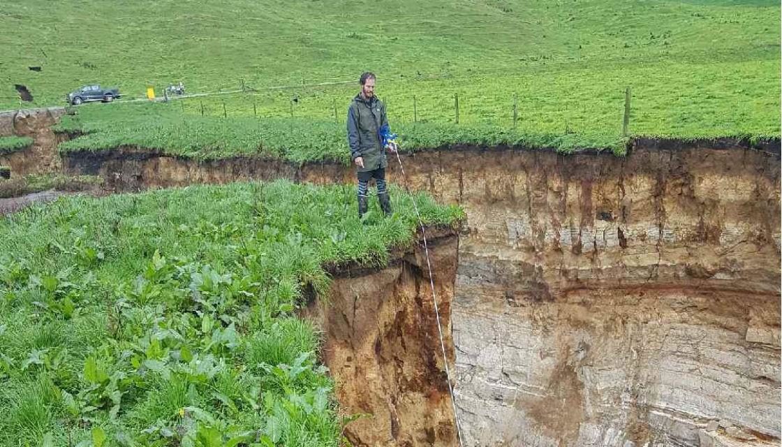 Colin Tremain next to the sinkhole