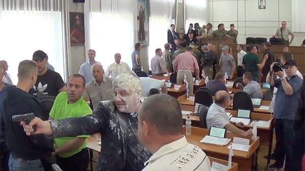 Man pours milk on politician
