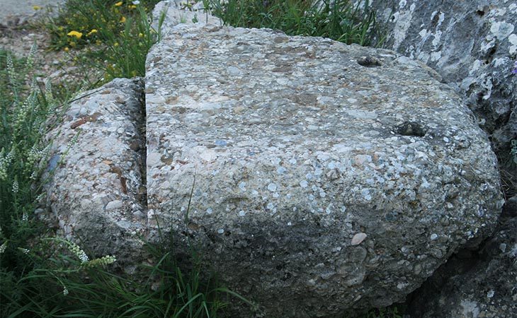half cut stone column mycenaean site