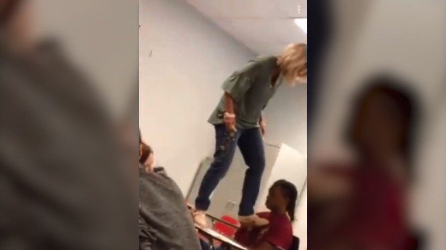 Click to enlarge Teacher standing on desk
