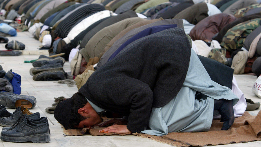 Click to enlarge Muslims pray outside a mosque in Afghanistan