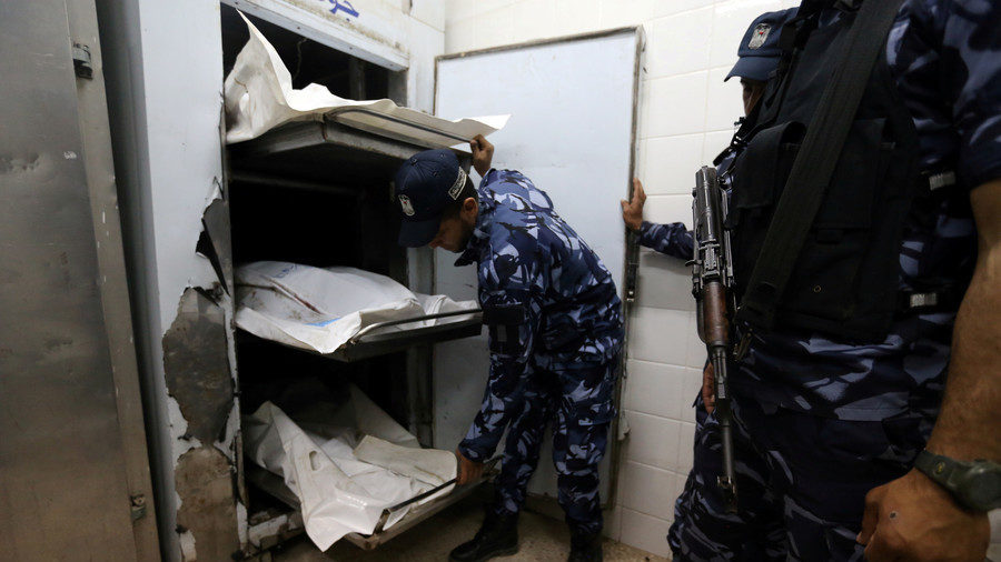 Hamas police officers near the bodies of explosion victims
