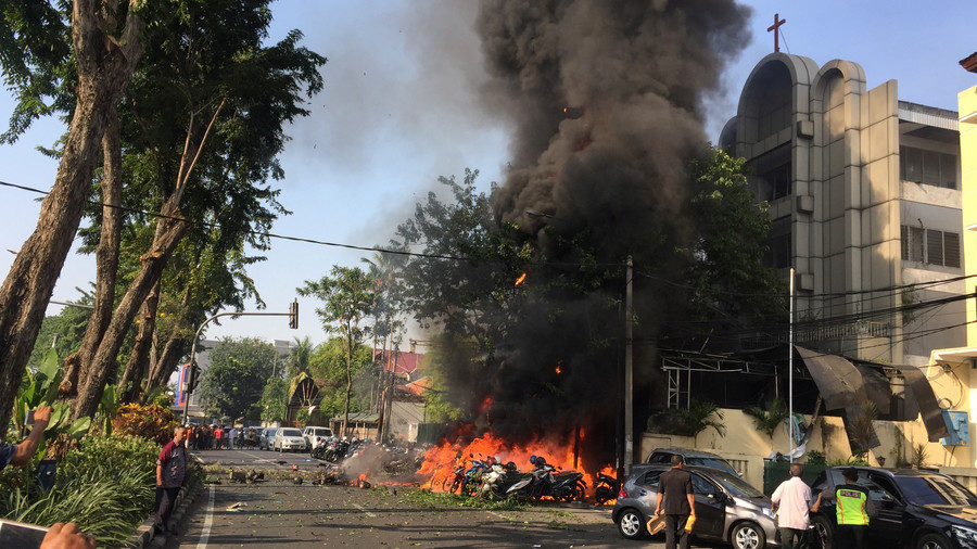Motorcycles burn following a blast at the Pentecost Church Central Surabaya (GPPS), in Surabaya