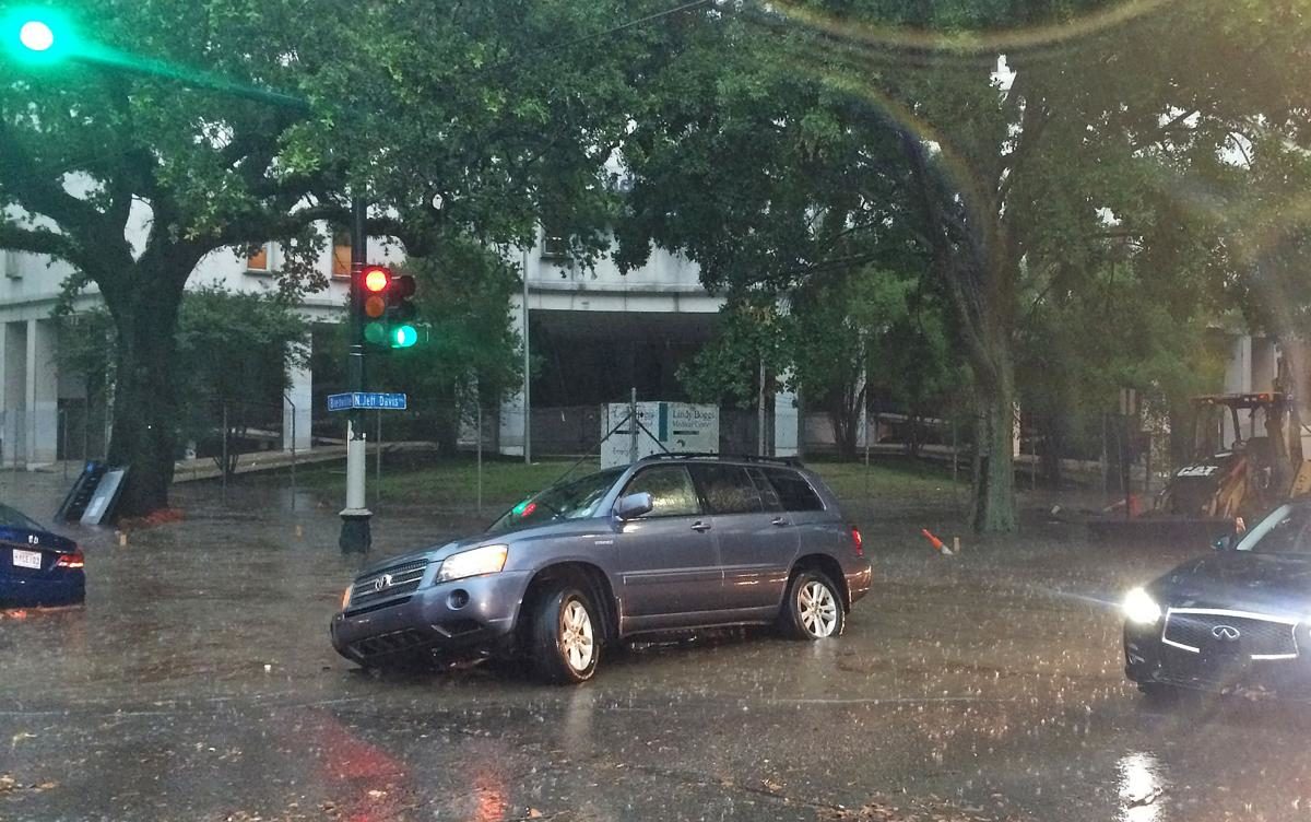Click to enlarge Cars are seen stuck in a hole on the corner of Bienville Street and Jefferson Davis Parkway after severe weather caused heavy rain in New Orleans, La., Friday, May 18, 2018.