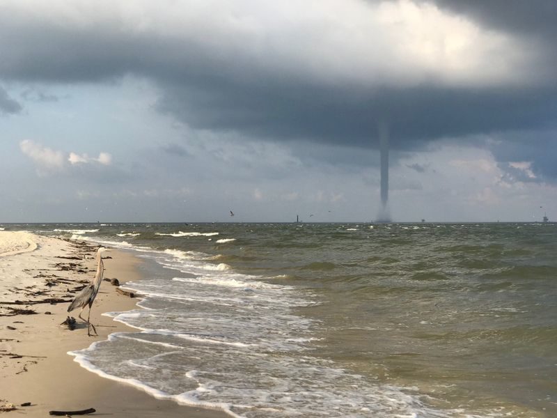 Click to enlarge FOX10 News viewer Sam Sumlin provides these images of a waterspout seen from the beach at Fort Morgan.