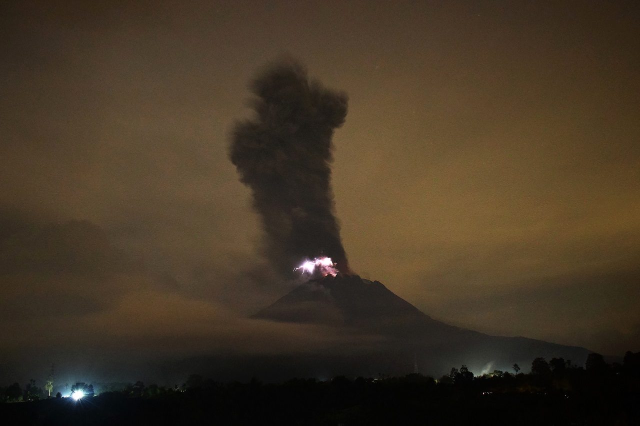 Click to enlarge This picture taken on May 20, 2018 shows the Mount Sinabung volcano spewing ash into the air and lightning from its crater in Karo.