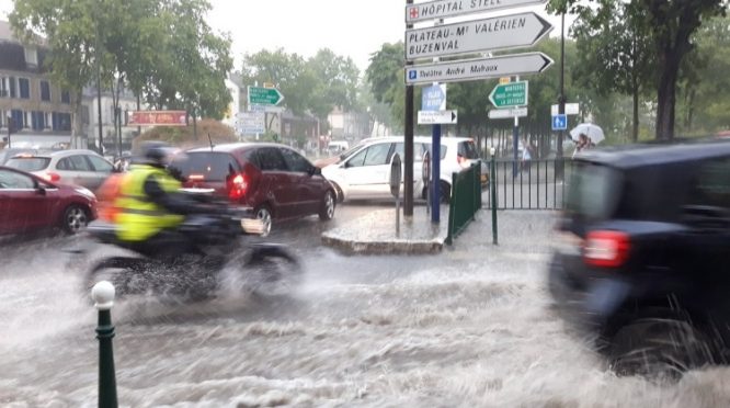 Drivers struggle on the Paris roads after rainfall caused flash floods