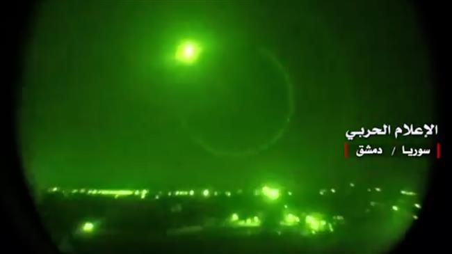 An image grab from a video released on May 10, 2018 by the media bureau of the Syrian army and broadcast on Syria's official TV shows Syrian air defense systems intercepting Israeli missiles