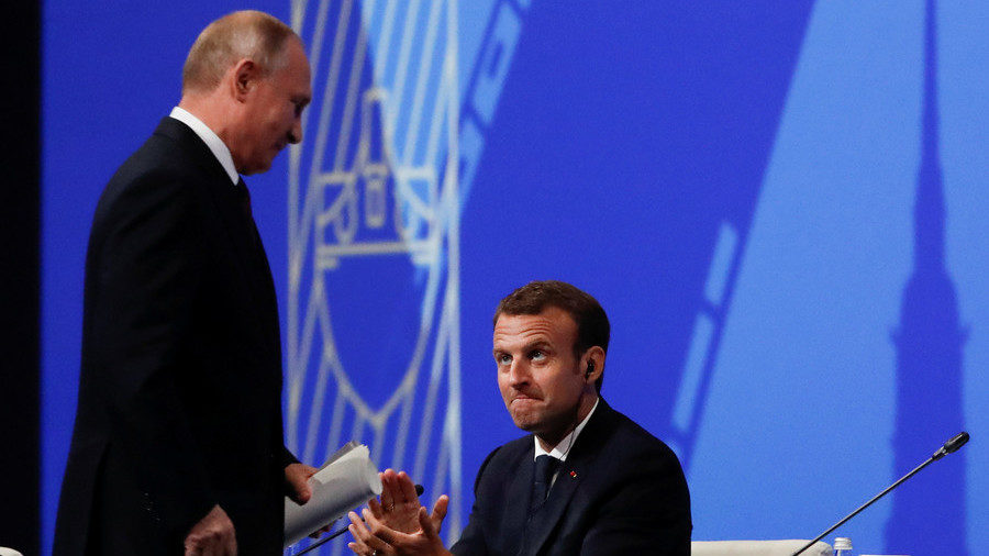 Russian President Vladimir Putin is applauded by his French counterpat Emmanuel Macron after delivering a speech during a session of the St. Petersburg International Economic Forum (SPIEF), Russia May 25, 2018.