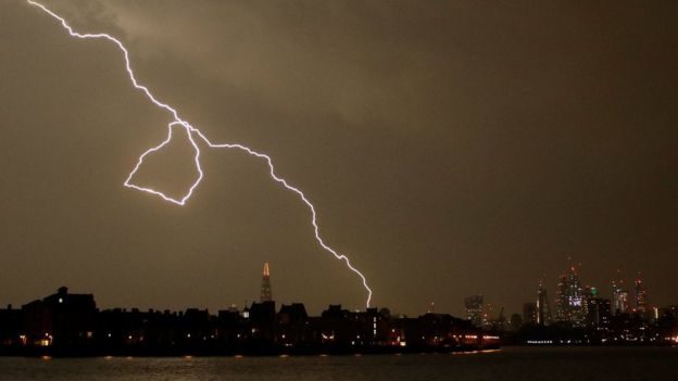Click to enlarge The Met Office has warned of flooding and possible damage to buildings from lightning, which is pictured here striking over the city of London