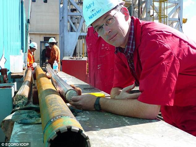 Click to enlarge Associate Professor Jody Webster on board the Great Ship Maya with a fossil core from the Great Barrier Reef