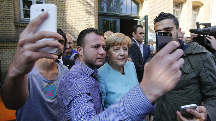 Migrants from Syria and Iraq take selfies with German Chancellor Angela Merkel