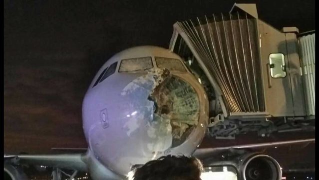Click to enlarge American Airlines plane damaged by hailstorm