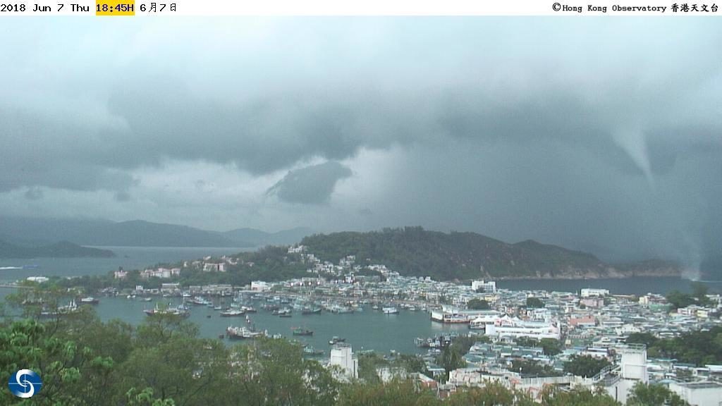 A waterspout seen near the right.