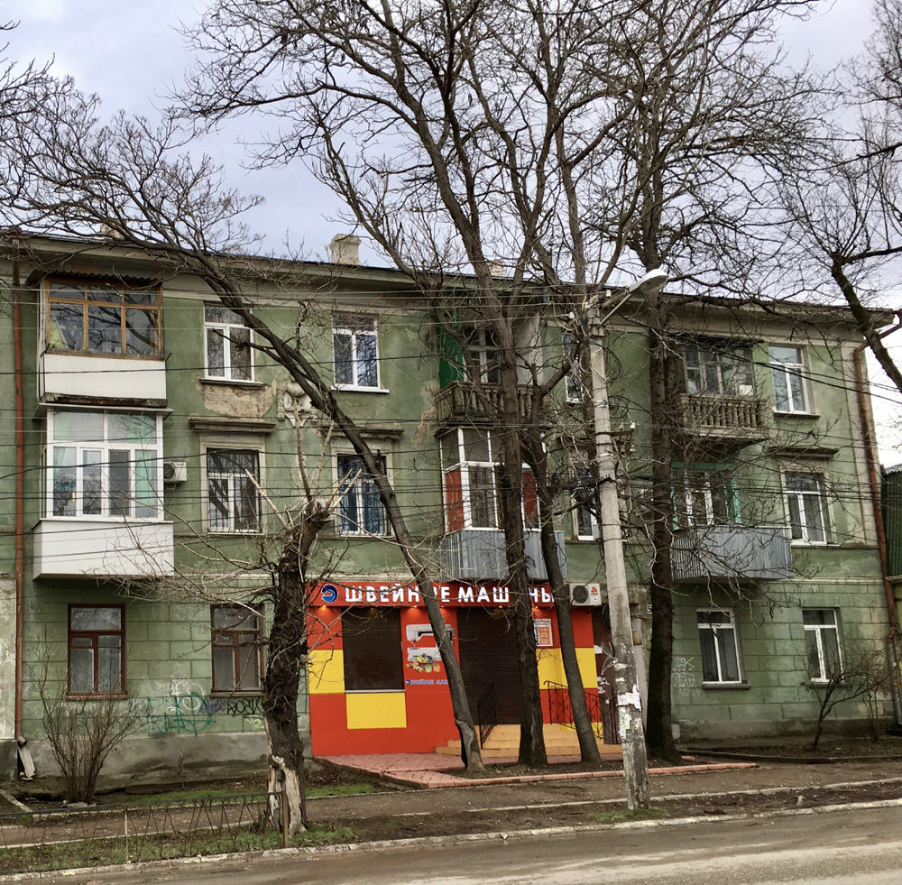Old-style Soviet apartment block with new shop at street level