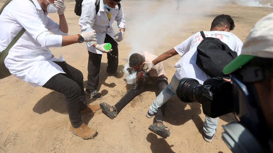 Palestinian protester Haitham Abu Sabla surrounded by medics