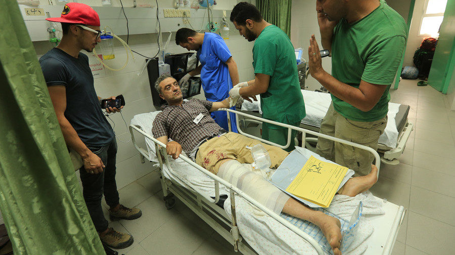 Click to enlarge Photographer lies in a hospital bed