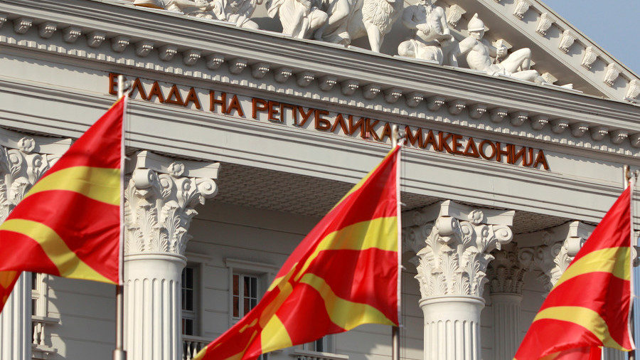 Macedonian flags fly in front of the government building in Skopje