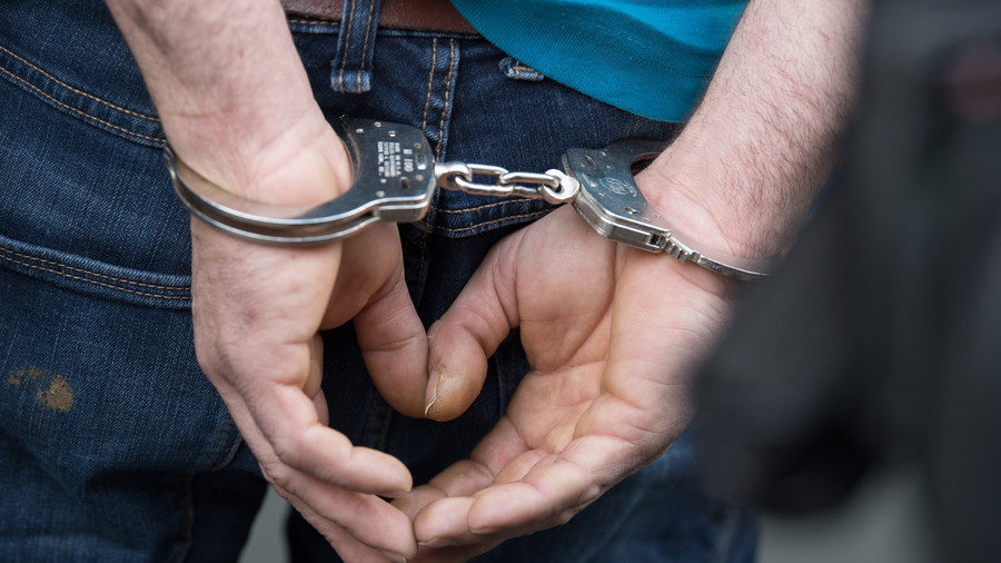 Click to enlarge handcuffed man