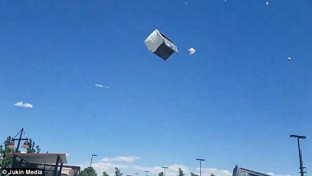 Click to enlarge Liquid from the Porta Potty spilled out of the cabin as the portable plastic toilets swirled in the air.