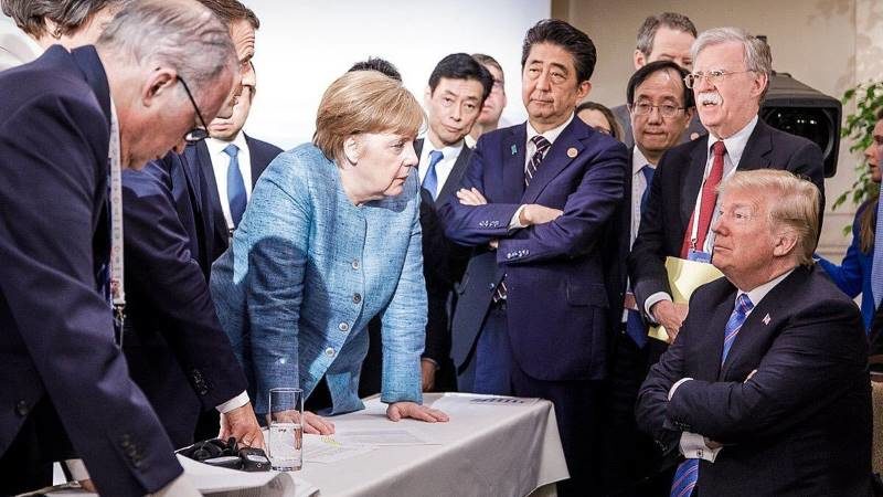 trump g7 arms crossed merkal bolton Abe