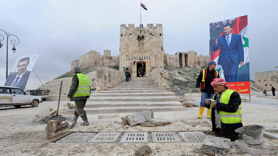 Workers repair the damage in front of Aleppo's historic citadel on January 31, 2017