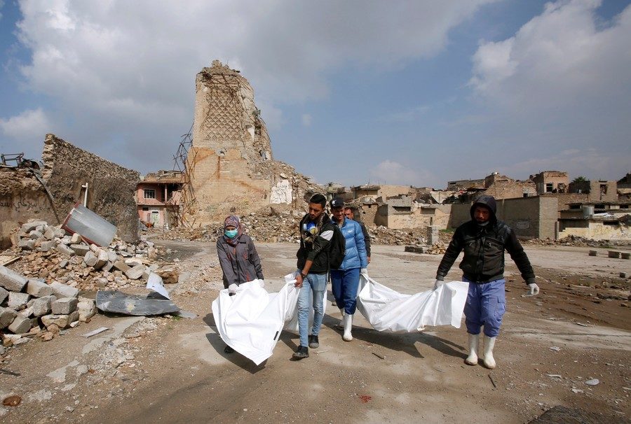 Click to enlarge Activists collect corpses in Mosul, Iraq on February 28, 2018