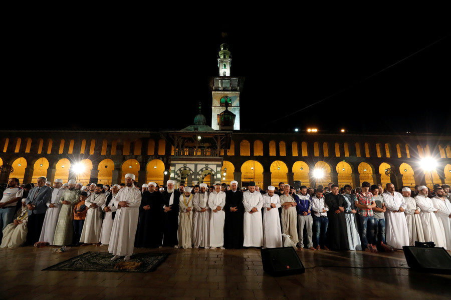 Men pray at the Umayyad mosque in Damascus, Syria on June 12, 2018