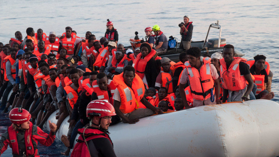 Click to enlarge Migrants on an inflatable boat