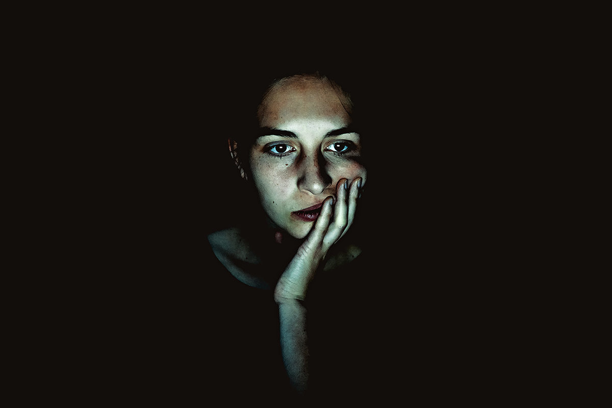 Click to enlarge woman lit by computer screen